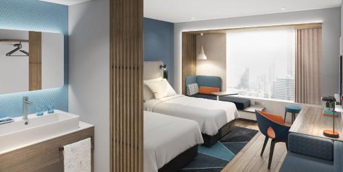 ein Hotelzimmer mit 2 Betten und einem Waschbecken in der Unterkunft Holiday Inn Express Binzhou City Center, an IHG Hotel in Binzhou