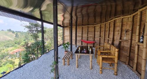a room with two chairs and a table in a building at Cabaña Starka & Jacuzzi in Marinilla