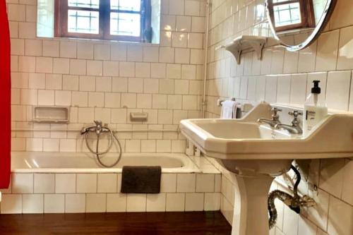a white bathroom with a sink and a tub at La Casa del Teide, d-espacios in La Orotava