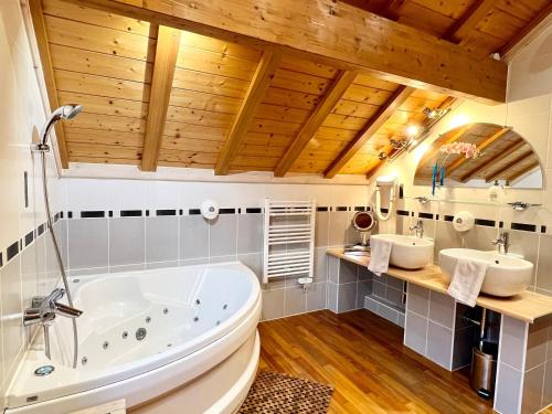 a bathroom with two sinks and a tub at Chalet Montagne avec Spa, Sauna & Proche Pistes - Gérardmer - FR-1-589-114 in Gérardmer