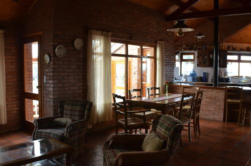 a dining room with a table and chairs at Posada Los Mimbres in Gaiman