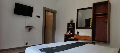 a bedroom with a bed and a sink and a mirror at ZiFa Mandalika in Kuta Lombok
