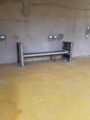 an empty room with a bench in a room with water at Água Doce Hospedagemw in Sao Jorge