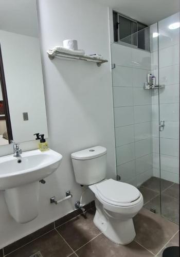 a bathroom with a toilet and a sink and a shower at Casalba in Bello