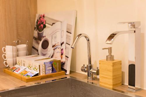 a kitchen counter with a sink and a faucet at Traveller-Inn Zhongzheng Library in Taitung City