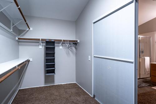a walk in closet with a glass door and a staircase at 5BR 3BA Family friendly entire home w pool, spa, games, tvs, and more in Las Vegas