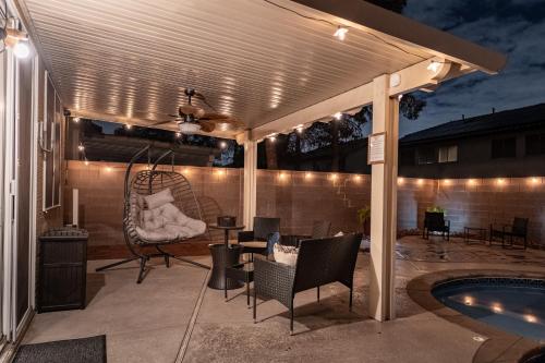 a pergola over a patio next to a pool at 5BR 3BA Family friendly entire home w pool, spa, games, tvs, and more in Las Vegas