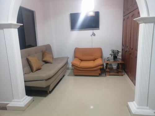 a living room with a couch and a chair at Apartamento Rionegro cerca al Aeropuerto in Rionegro