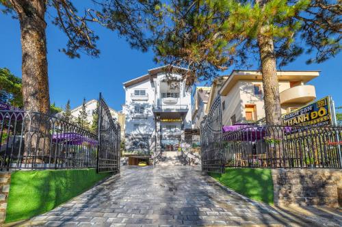 a cobblestone street in front of a building with trees at Savio Hotel Trieu Viet Vuong in Da Lat