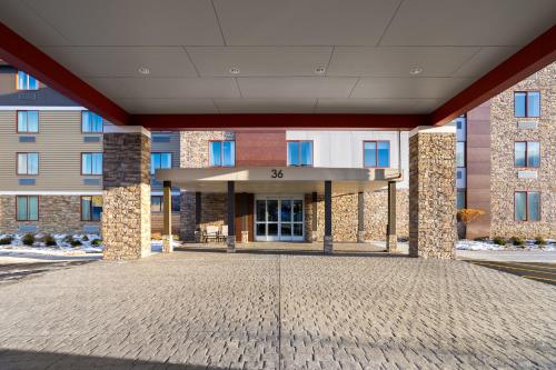 a large brick building with a front entrance at La Quinta Inn & Suites by Wyndham Williston Burlington in Williston