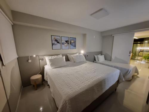 En eller flere senge i et værelse på Luxo quadra mar Balneario