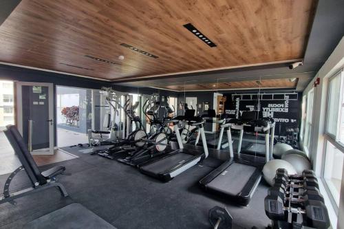 a gym with several treadmills and exercise machines at Barranco Aparment Luxury in Lima