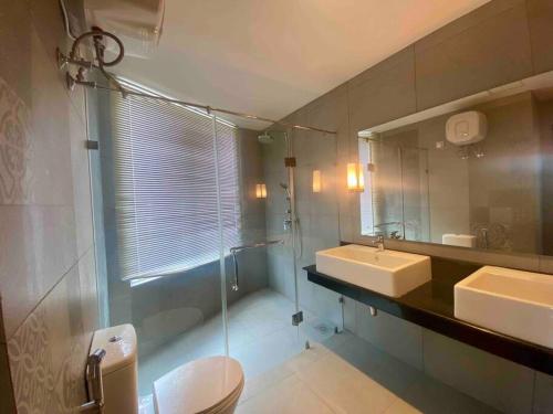 a bathroom with a toilet and a sink and a mirror at Oceanfront condo 3-2-01- Nilaveli in Nilaveli