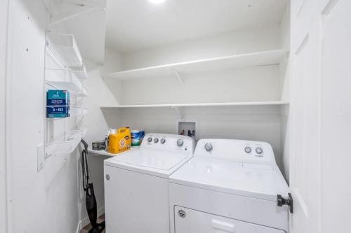 a white laundry room with a washer and dryer at Just Minutes from UVU Fully Fenced Backyard in Orem