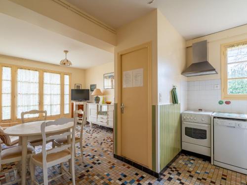a kitchen with a table and a dining room at Appartement 4 pers, Pieds des Pistes Cyclables, Terrasse, BBQ, Proche Plages et Activités - FR-1-50-107 in Mimizan