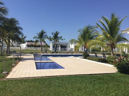una piscina con palmeras y un complejo en MM VILLA, en Panamá