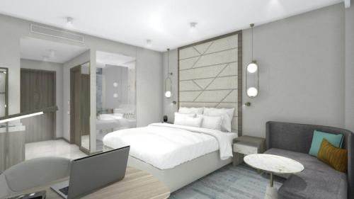 een slaapkamer met een bed en een bureau met een laptop bij Crowne Plaza Constanta - Mamaia Beach, an IHG Hotel in Mamaia