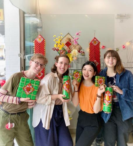 a group of people holding up christmas presents at City Hostel Da Nang in Da Nang