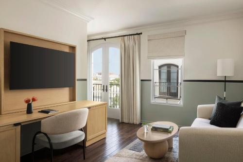 a living room with a tv and a couch at Kimpton Canary Hotel by IHG in Santa Barbara
