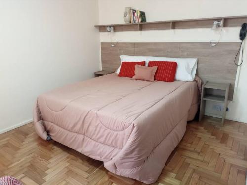 a bedroom with a large bed with two pillows on it at Confortable departamento en Retiro in Buenos Aires