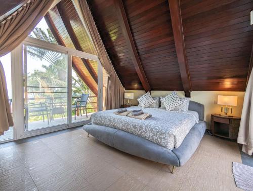 a bedroom with a bed and a large window at Villa Manipura in Ko Chang