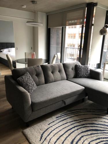 a living room with a couch and a table at Downtown Luxe in Vancouver