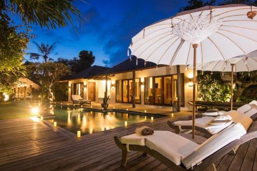 a villa with a swimming pool at night at Sunset Beach Villa Zanzibar 