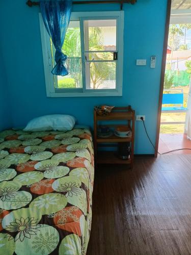 a bedroom with a bed and a window at Chill land house in Bang Tao Beach