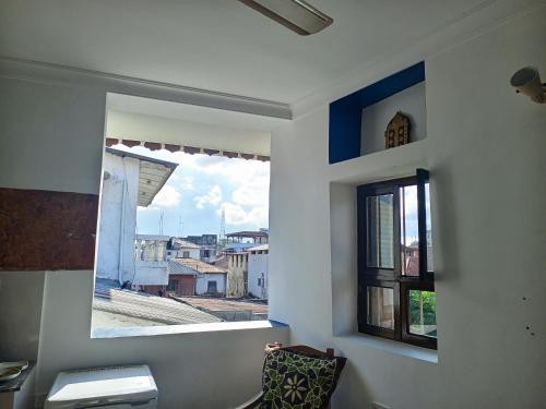 a bathroom with a window with a view of a city at Seafarers Loft in Stone Town