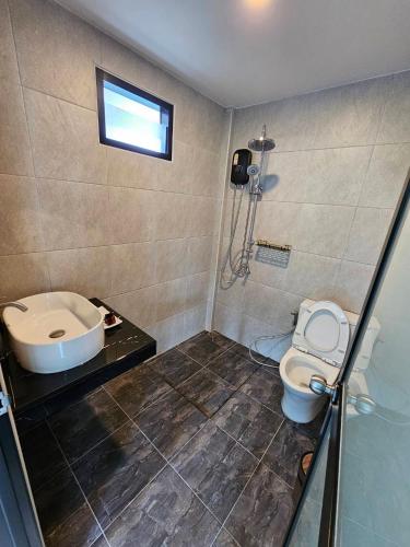 a bathroom with a shower and a toilet and a sink at The Hill resort Thalang in Phuket
