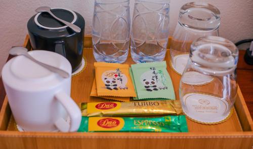a tray with glasses and food and drinks on a table at Relaxful Hotel泊岸酒店 in Luang Prabang