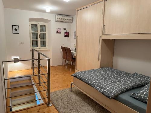 a bedroom with a bunk bed and a staircase at Casa Palfy in Punat