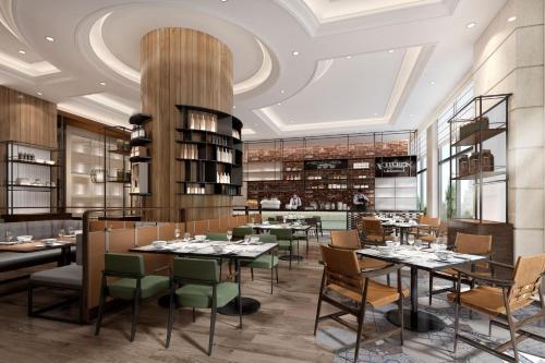 a restaurant with tables and chairs in a room at Sheraton Shanghai Pudong Riverside in Shanghai