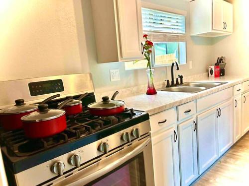 a kitchen with three pots on the stove at Walk To Americana on Brand. in Glendale
