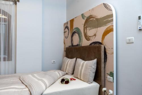 a bedroom with a bed with a painting on the wall at Premium apartment in new cairo in Cairo