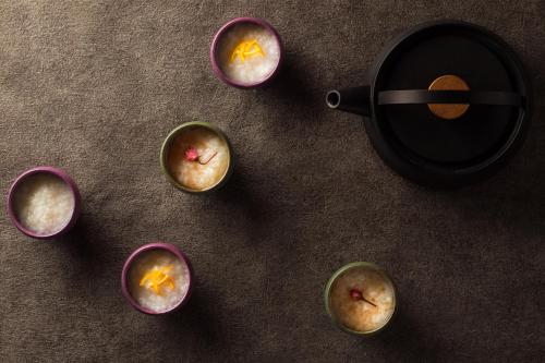 a group of cupcakes on a table with a pan at Grand Mercure Ise-shima Resort & Spa in Shima