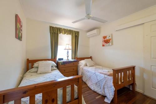 a bedroom with two beds and a window at Your unit at Southside Central in Bundaberg