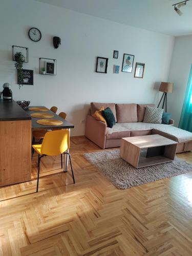 a living room with a couch and a table at Krstić_lux apartman in Subotica
