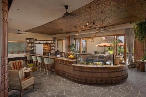 a restaurant with a bar with chairs and tables at Six Senses Southern Dunes, The Red Sea in Khuff