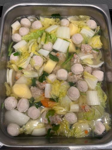 a tray filled with a pot of soup with vegetables at THE HUB SURATTHANl in Surat Thani