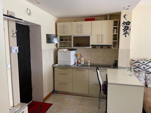 a kitchen with white cabinets and a counter top at Apartament cu un dormitor / One bedroom apartment in Satu Mare