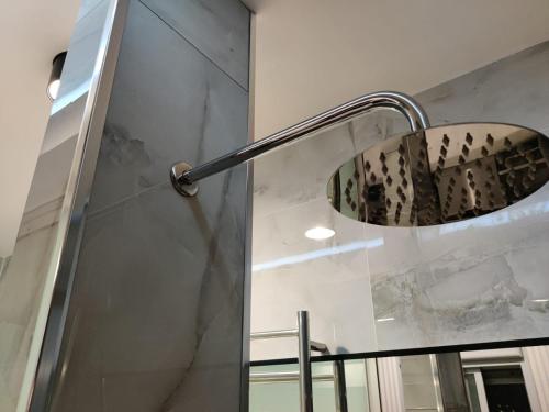 a shower with a shower head in a bathroom at Luxury open-space apartments by the sea in Ashdod