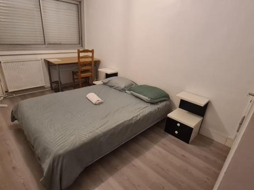 a bedroom with a bed and a desk and a chair at APPARTEMENT EN PLEIN CENTRE VILLE PESSAC AVEC 3 CHAMBRES in Pessac