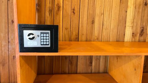 a remote control sitting on top of a wooden shelf at Gita Gili Bungalow in Gili Air