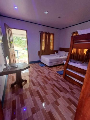 1 dormitorio con 2 literas y suelo de madera en Thor's Cabin-Camp Asgard, en Catarman