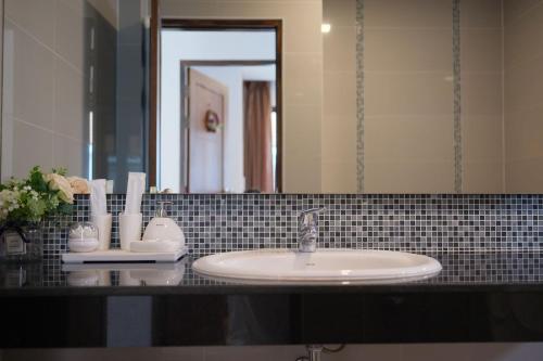 a bathroom counter with a sink and a mirror at WangTanChiangMai PoolVilla精品泳池别墅 in Chiang Mai