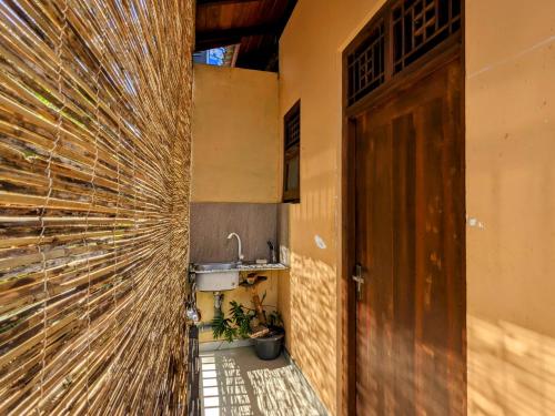 a hallway with a wall with a sink and a door at Lavish Lodge, Tangalle, Sri Lanka in Tangalle