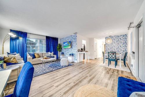 a living room with a couch and a table at Stylish - Water View Condo - Palm Wave Says in Coconut Creek