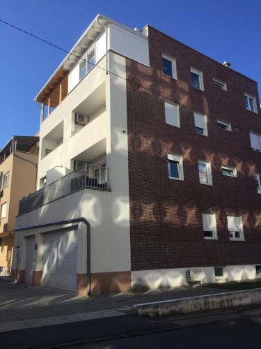 a tall brick building with a garage next to it at Velesajam in Zagreb