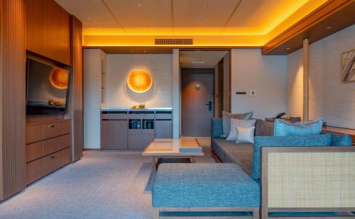 a living room with a couch and a table at Hotel Okura Kyoto Okazaki Bettei in Kyoto